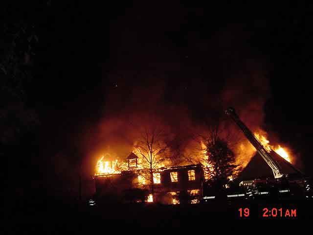 Crews operating in a defense mode on a first due fully involved mansion.